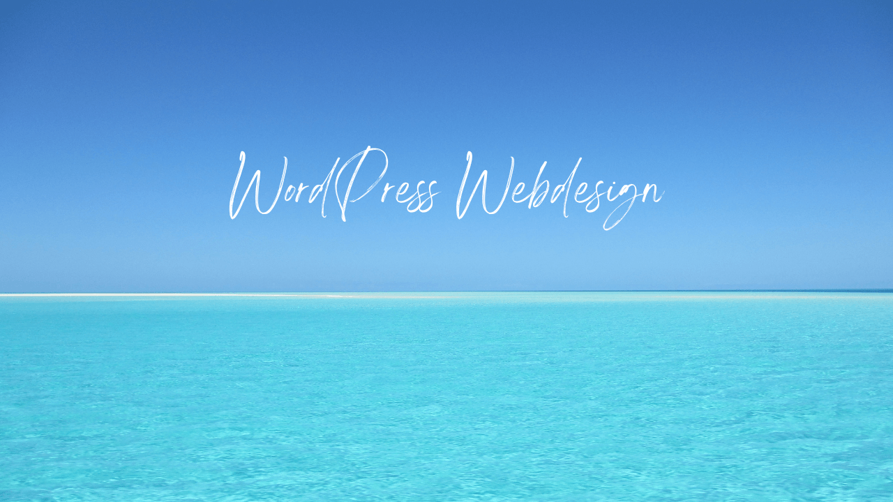 A beautiful beach with fine sand and a crystal clear blue sky and an inscription for WordPress web design, created by Billy Kasis in 2023.