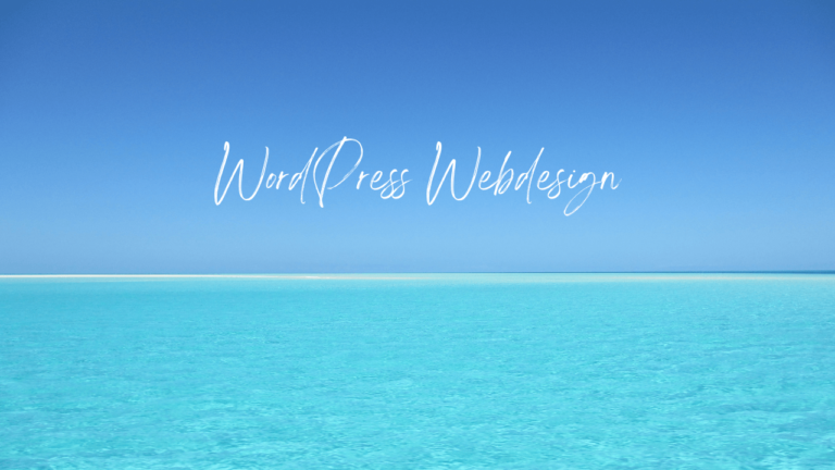A beautiful beach with fine sand and a crystal clear blue sky and an inscription for WordPress web design, created by Billy Kasis in 2023.